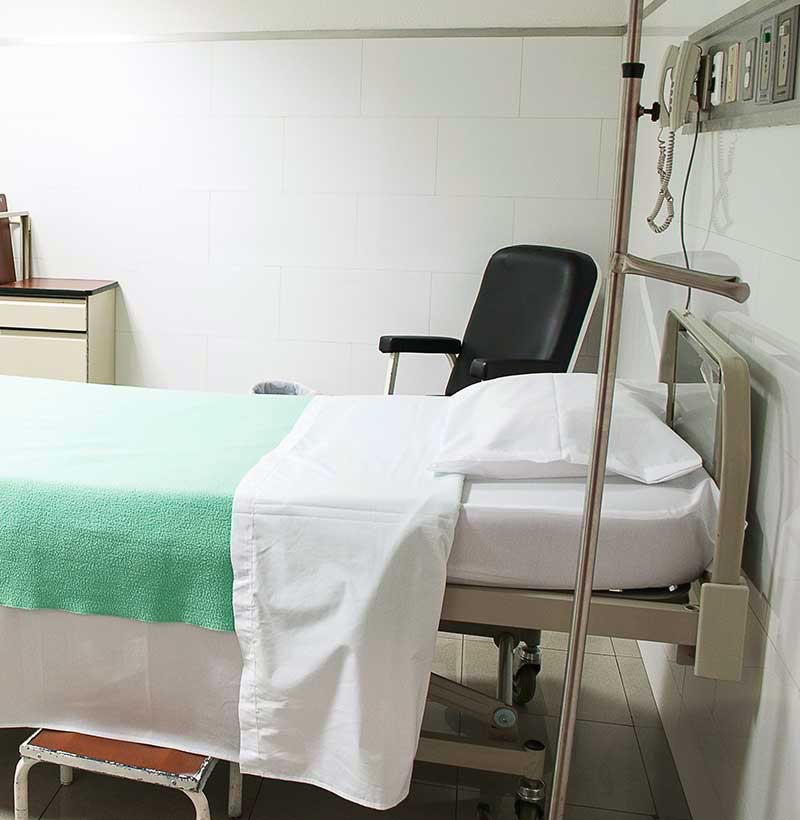 medical bed in hospital with green sheet